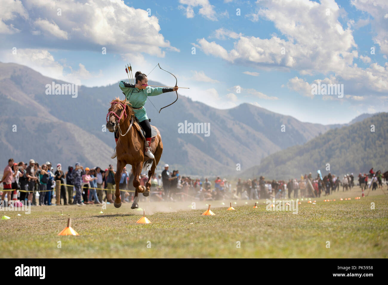 Il lago di Issyk-Kul, Kirghizistan, 6 Settembre 2018: Donna competere nel tiro con l'arco a cavallo gioco Foto Stock