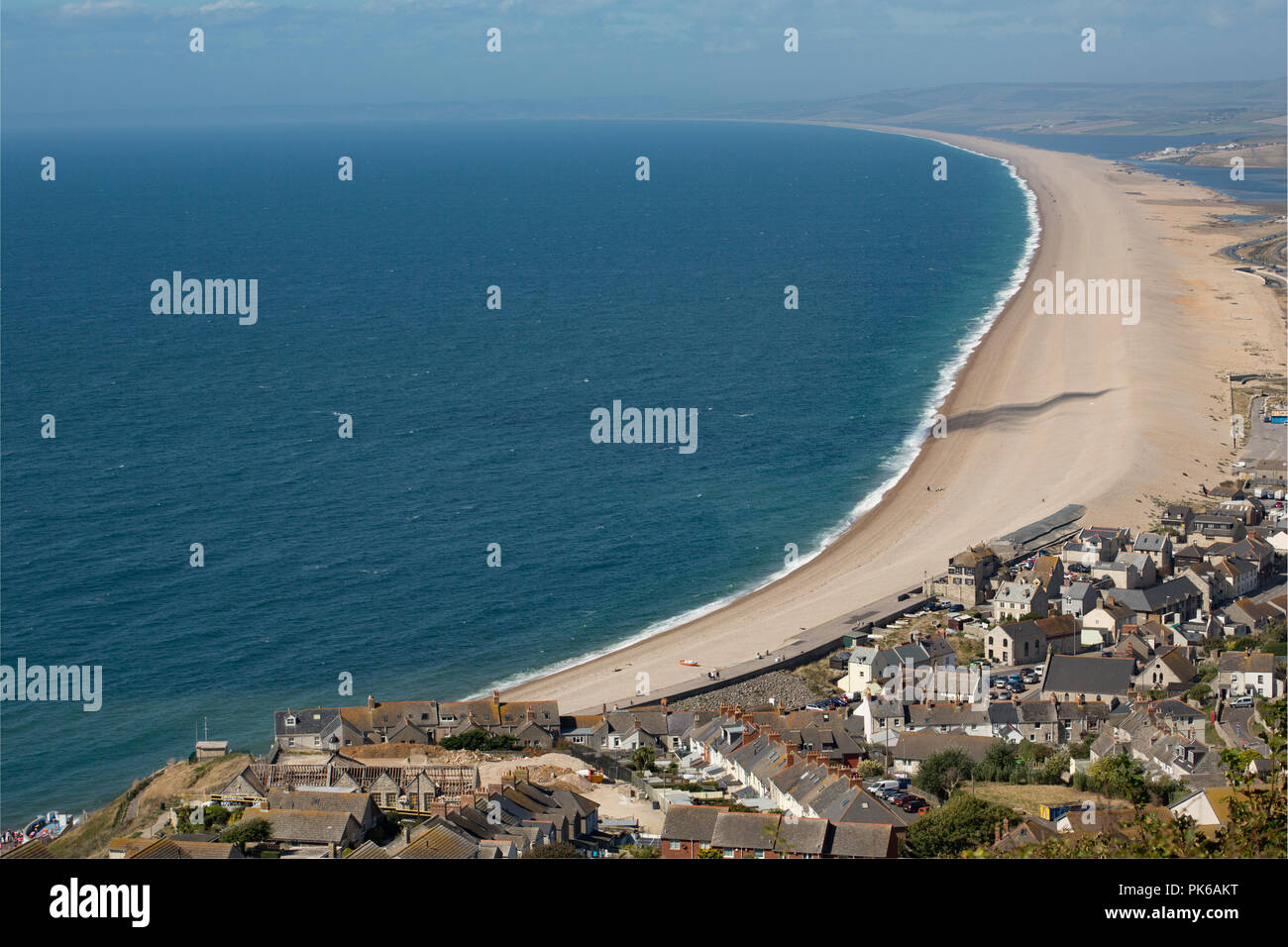 Guardando ad ovest lungo Chesil Beach in una giornata di sole con un vento onshore creazione di alcuni surf. Il Dorset England Regno Unito GB Foto Stock