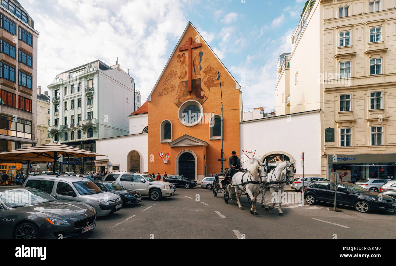 Vienna, Austria - 1 Ottobre, 2017: una carrozza a cavalli contro la Chiesa dei Cappuccini che ospita cripta imperiale sul Neuer Markt square Foto Stock