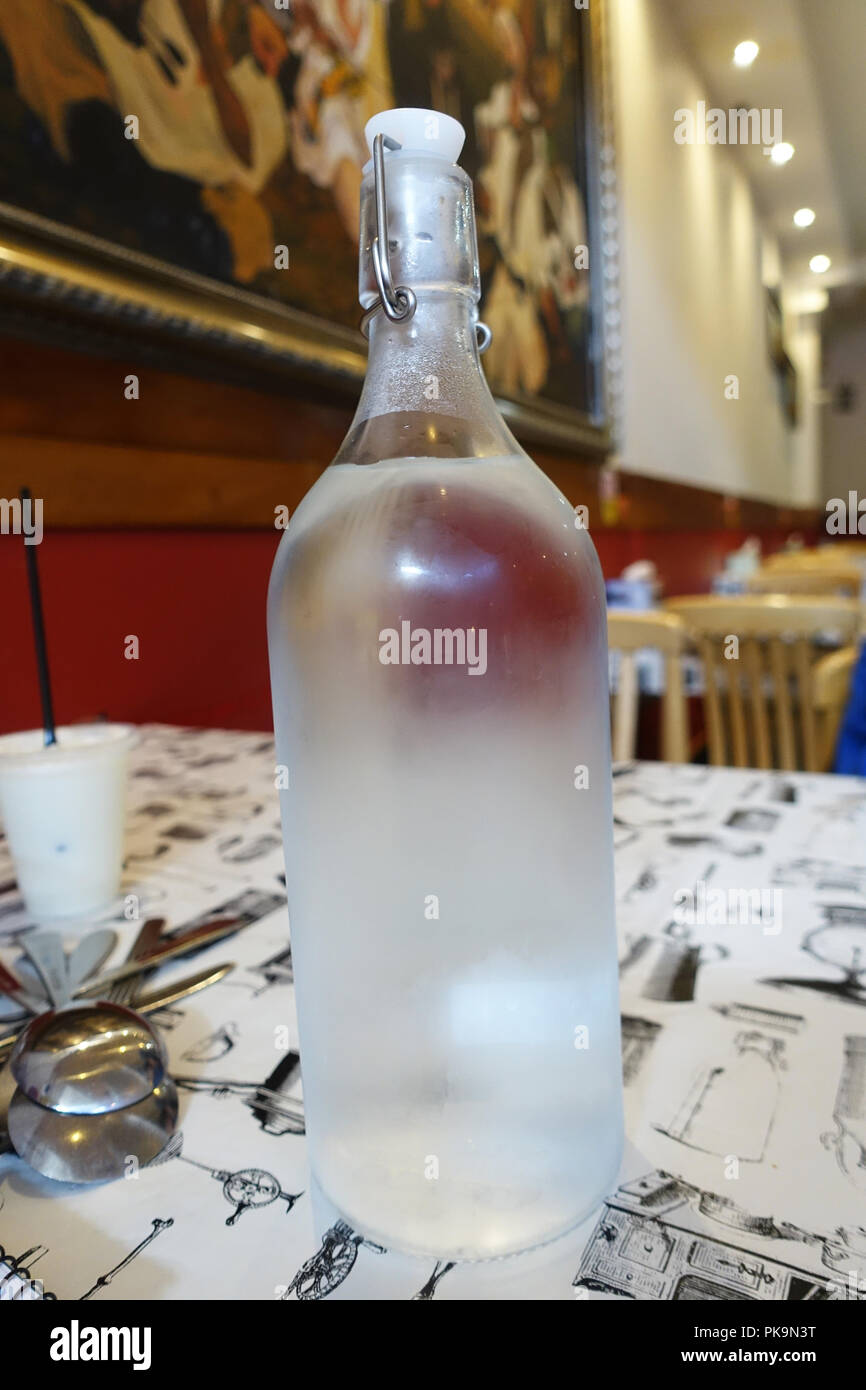 Una bottiglia di acqua fredda su un tavolo Foto Stock