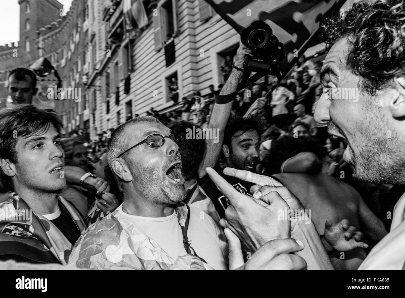 Membri del Bruco (Caterpillar) Contrada celebrare vincere il Palio, Piazza del Campo, il Palio di Siena, Siena, Italia Foto Stock