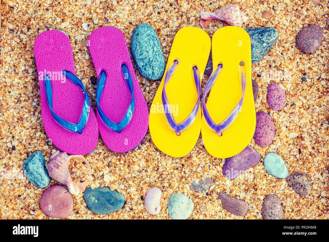 Scena di spiaggia. Il flip-flop sandali adagiato sul mare coquina Foto Stock