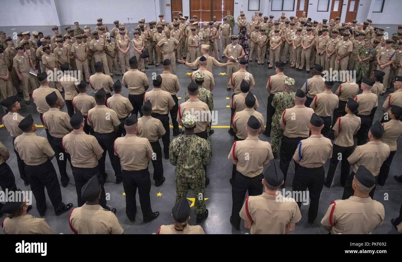 Grandi laghi, Ill. (Agosto 7, 2018) Capt. Erik Thors, comandante del reclutamento di formazione di comando (RTC), parla al RTC chief petty officer selectees e i capi pasticcio nella flotta del Pacifico drill hall in RTC. Sessantotto RTC prima classe sottufficiali sono stati selezionati per il capo. Più di 30.000 reclute graduate annualmente dalla marina è solo di boot camp. Foto Stock