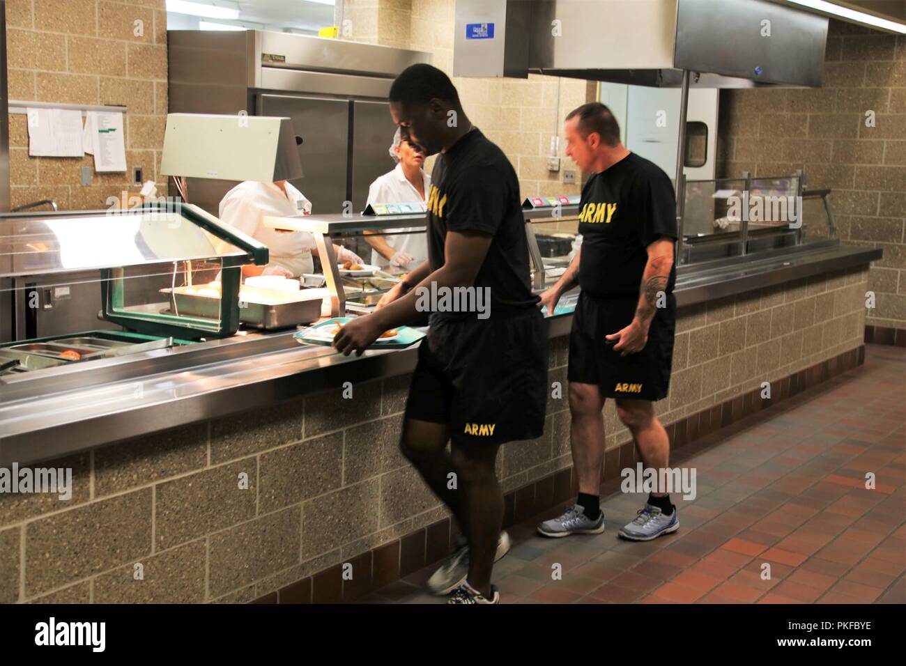 I soldati ricevano cibo da dipendenti con l'appaltatore DCT Inc. su 3 Agosto 2018, nell'impianto di pranzo nell'edificio 50 a Fort McCoy, Wis. ogni volta un grande esercizio come una lotta contro la formazione per il supporto di esercizio avviene a Fort McCoy, migliaia di truppe hanno bisogno di essere alimentate. L'installazione del cibo-service team assicura che il bisogno è sempre soddisfatte. Il team che include il cibo Program Management Office e la sussistenza di alimentazione Ufficio di gestione con il Fort McCoy disponibilità logistica centro; il cibo full-service DCT contraente Inc.; e i fornitori di prodotti alimentari quali alimenti Sysco di Baraboo, Wis. Foto Stock