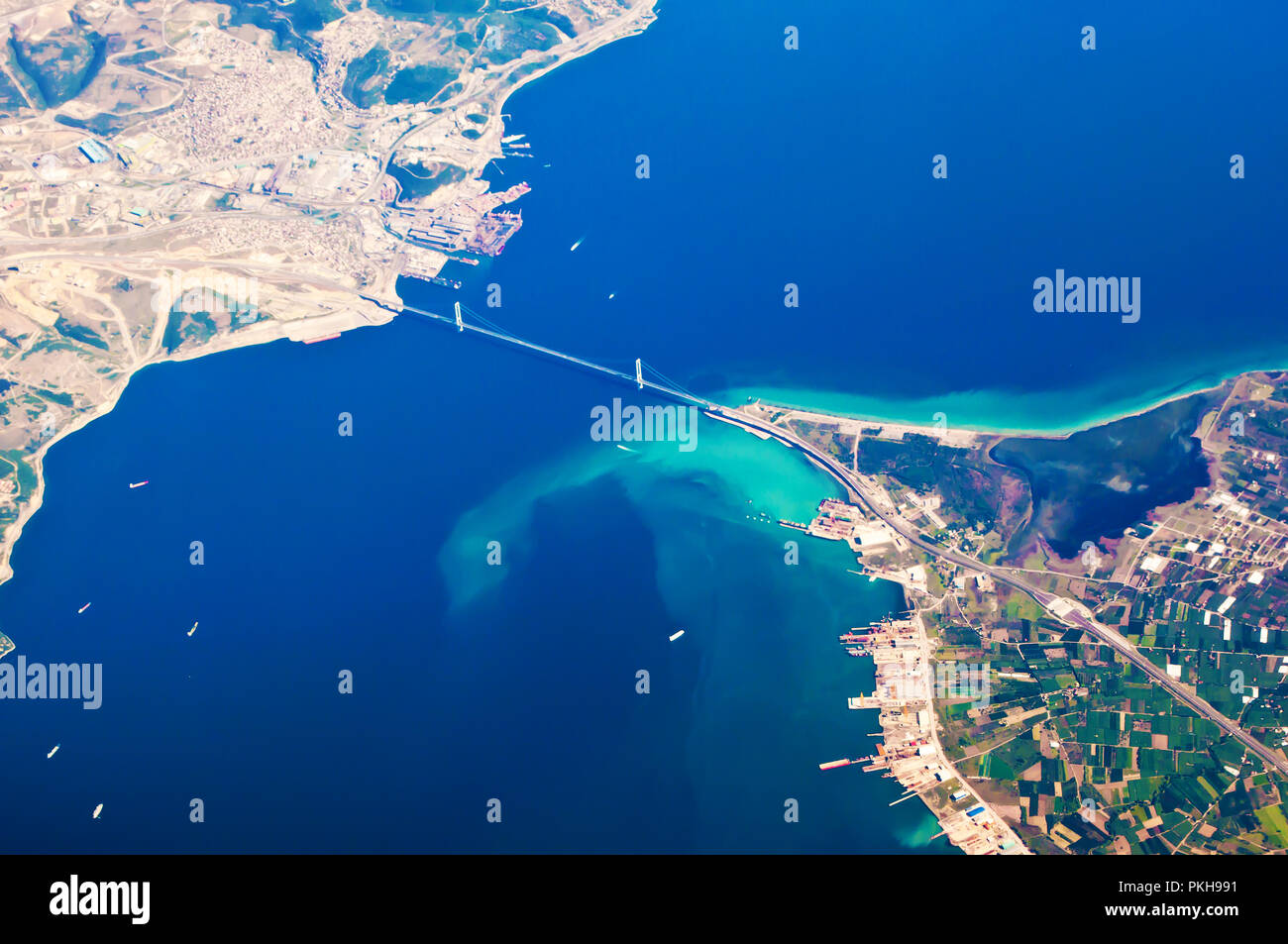 Vista aerea di Osmangazi Koprusu sospensione in acciaio ponte attraverso il golfo di Izmit, vicino alla città di Gebze, Hersek. Tante piccole navi in mare blu acqua, porto, doc Foto Stock