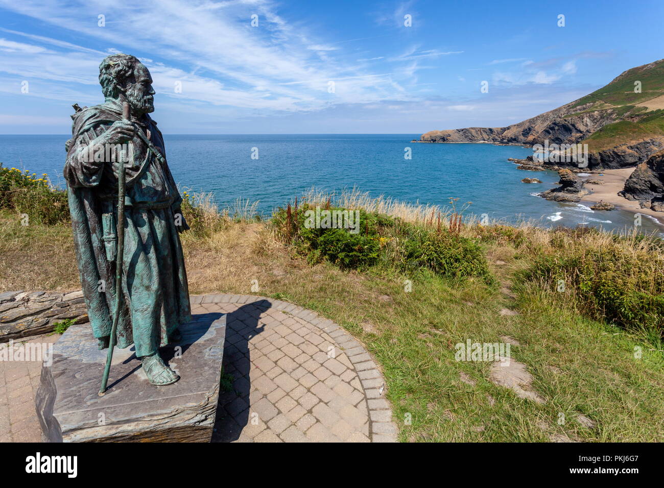 La statua di San Crannog sorge si affaccia sulla spiaggia di Llangrannog, Ceredigion, Galles Foto Stock