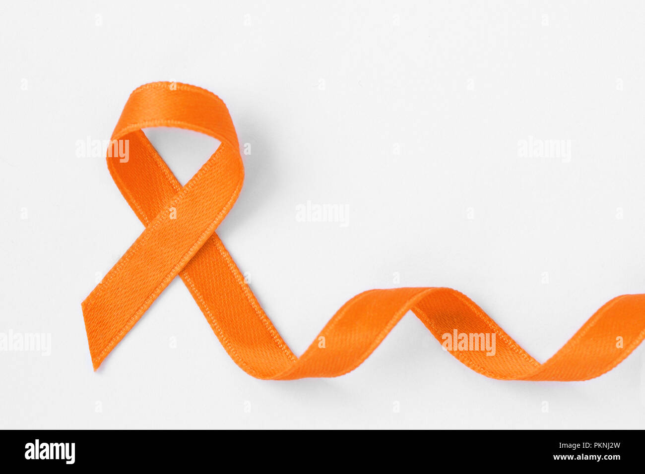 Nastro arancione su sfondo bianco - Concetto di consapevolezza di leucemia, cancro del rene associazione, la sclerosi multipla e l'abuso di animali Foto Stock