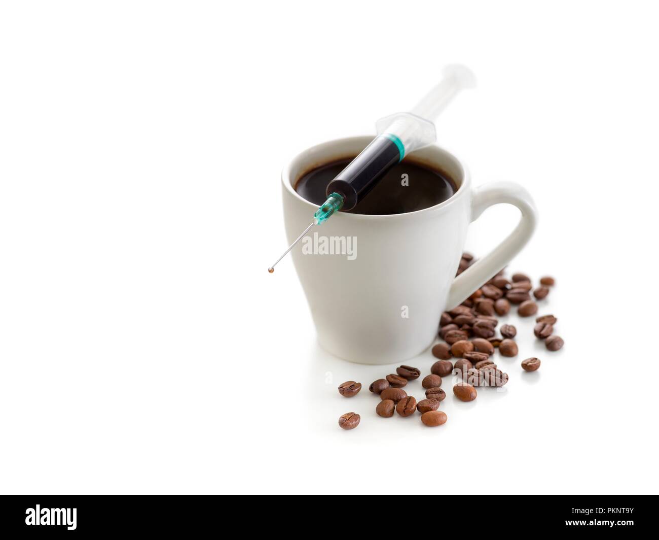 Tazza da caffè con fagioli e una siringa, concettuale studio shot. Foto Stock