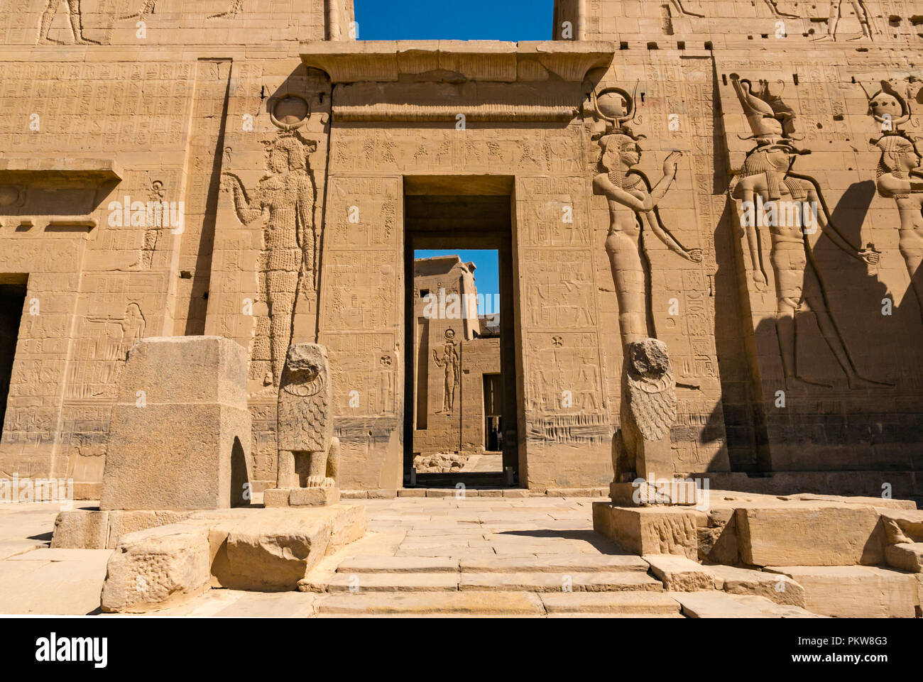 Pilone esterno e gateway con scolpito figure egiziane e geroglifici e il Tempio di Philae, Agilkia Isola, Fiume Nilo, Aswan, Egitto, Africa Foto Stock