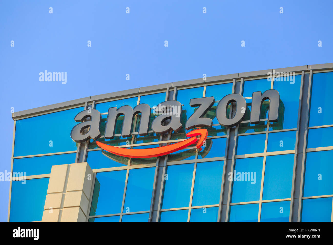 Sunnyvale, California, Stati Uniti d'America - 13 agosto 2018: closeup di Amazon segno sulla sommità del palazzo di vetro del grande campus Amazon nella Silicon Valley. Amazon è leader nel commercio elettronico e il cloud computing. Foto Stock