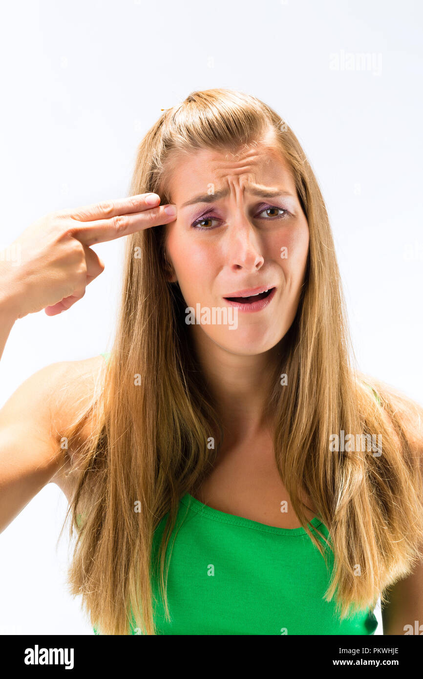 Premuto donna pistola fa gesto con le dita Foto Stock