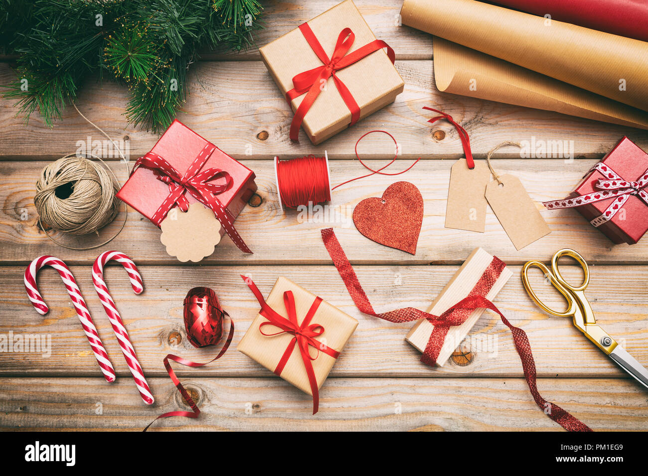 Preparazione di natale. Confezioni regalo avvolgimento su sfondo di legno, vista dall'alto Foto Stock