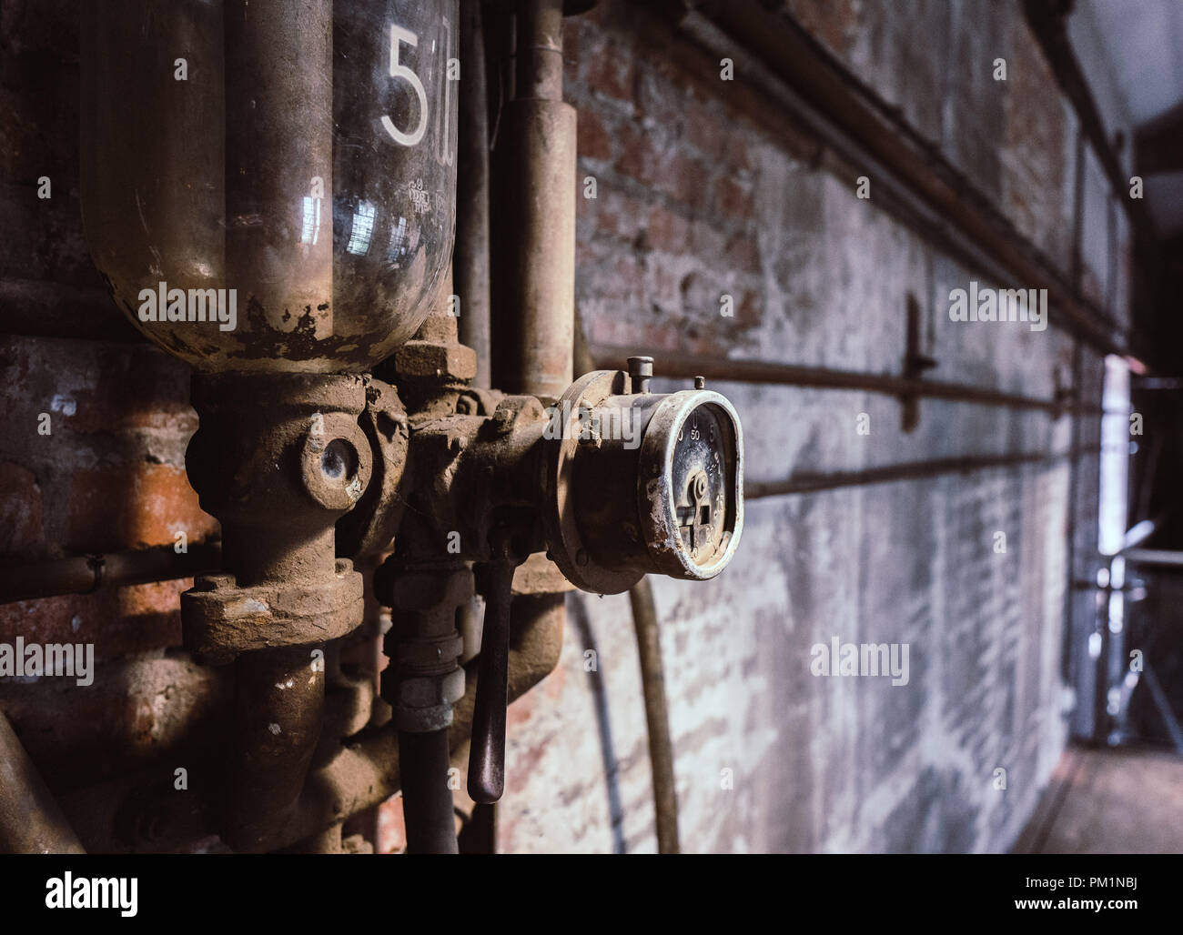 Parete con installazioni in una vecchia fabbrica Foto Stock