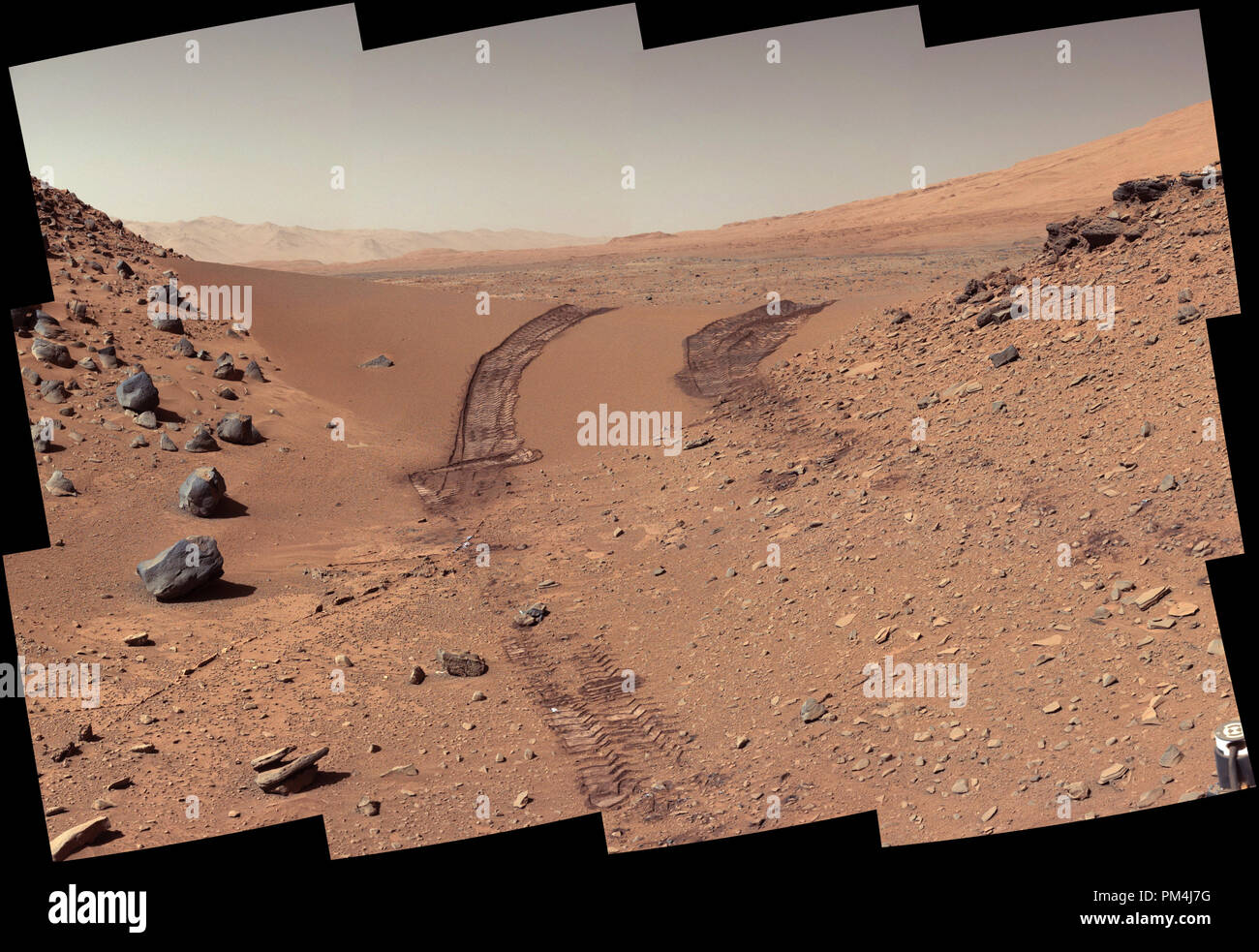 Questo sguardo indietro a una duna che la NASA la curiosità di Mars rover ha guidato in tutta è stata presa dal rover della fotocamera del montante (Mastcam) durante il 538th giorno Martian, o sol, di curiosità di lavoro su Marte (feb. 9, 2014). Il rover aveva guidato oltre le dune tre giorni prima. Per la scala, la distanza tra le parallele le tracce delle ruote è di circa 9 piedi (2,7 metri). La duna è di circa 3 metri (1 metro) alta nel mezzo della sua span attraverso un' apertura chiamato 'Dingo Gap". Questa vista è guardando verso est. L'immagine è stata equilibrata in bianco per mostrare che cosa la superficie marziana materiali sarebbe simile se sotto la luce della terra' Foto Stock