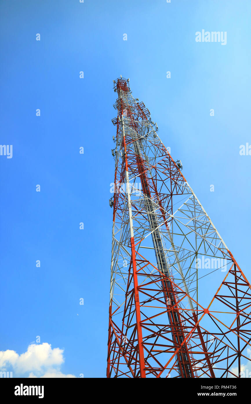 Rosso e Bianco Torre di telecomunicazione, Telefono Cellulare torre segnale contro blu luminoso cielo soleggiato Foto Stock