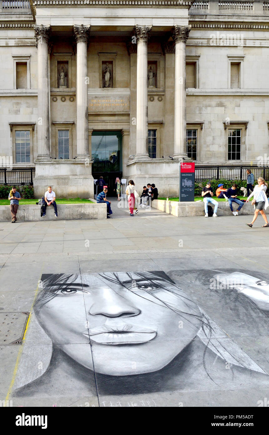 National Gallery, Trafalgar Square, Londra, Inghilterra, Regno Unito. L'artista di strada in verticale sul marciapiede Foto Stock