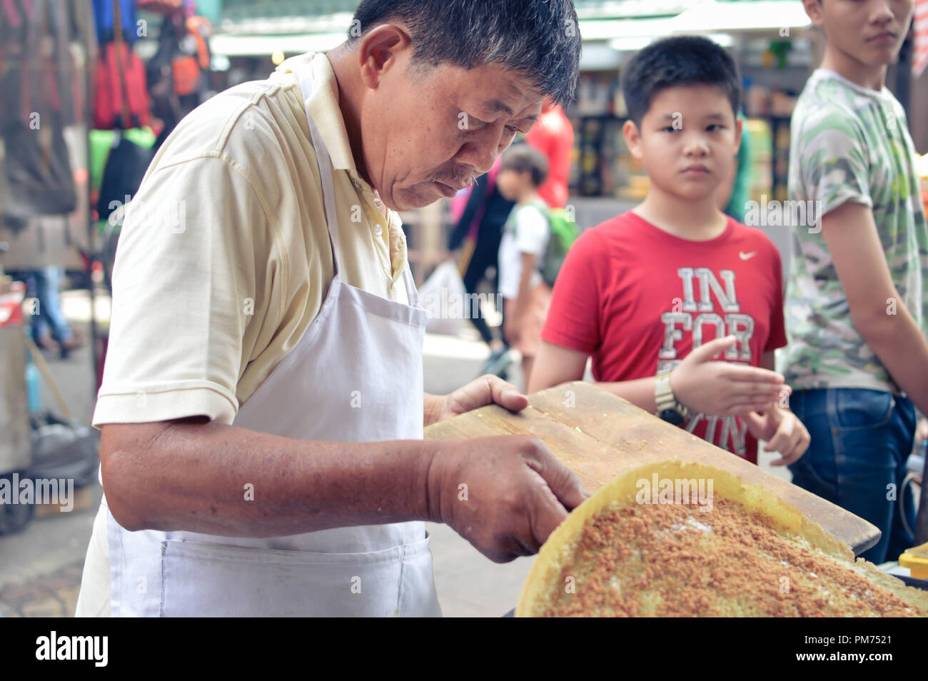 Kuala Lumpur, Malesia - 9 settembre, 2017: Cinese venditore ambulante tagli una deliziosa torta dolce con arachidi per le strade di Kuala Lumpur in Malesia Foto Stock