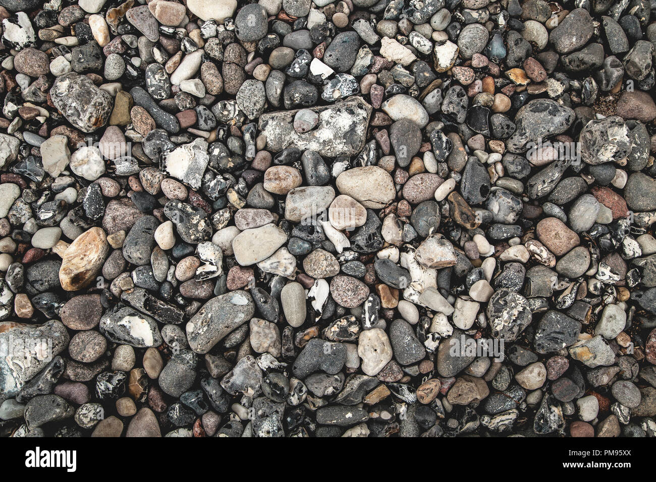 Spiaggia dettagli pietre jetsam close-up costa di massa Foto Stock