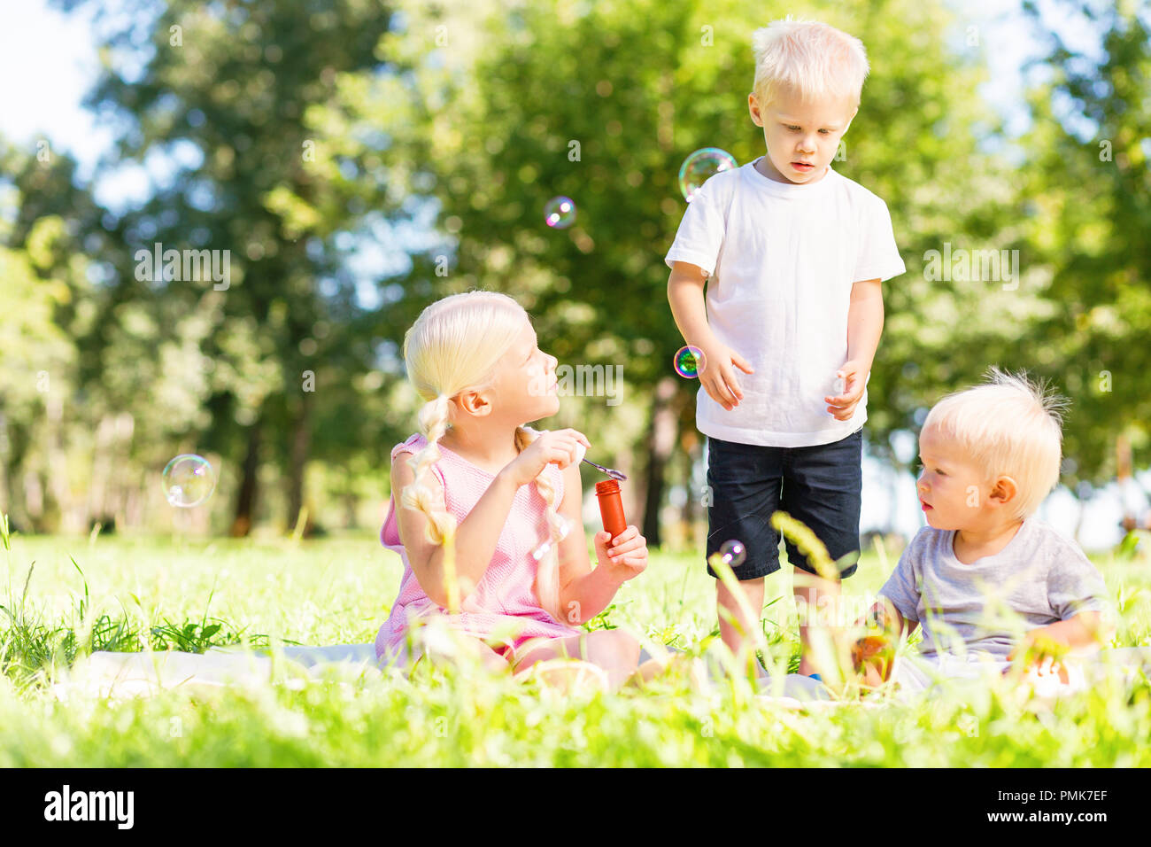 Emozionato i bambini giocando tutti insieme nel parco Foto Stock