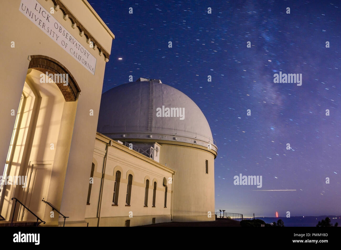 Vista notturna del centro storico di leccare osservatorio; il cielo stellato e la Via Lattea visibile in background; San Jose, California; lunga esposizione Foto Stock