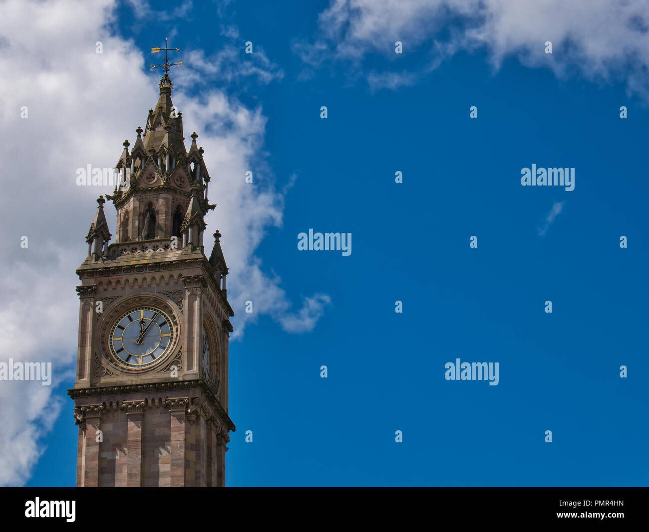 La torre con orologio a Belfast prima di cielo blu con nuvole di luce Foto Stock