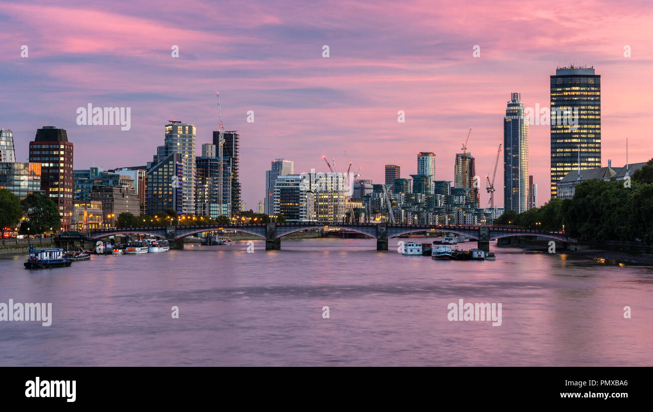 London, England, Regno Unito - 10 Settembre 2018: il sole tramonta dietro il fiume Tamigi e Lambeth Bridge con il moderno riverside skyline di ufficio blocchi, Foto Stock