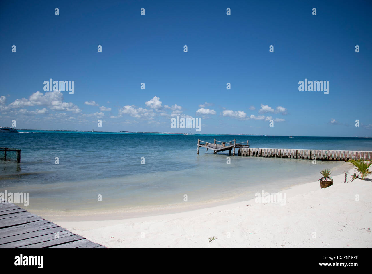 Azzurro acqua con spiaggia di sabbia bianca e la nuvola in cielo. La perfetta destinazione di pensionamento. Foto Stock