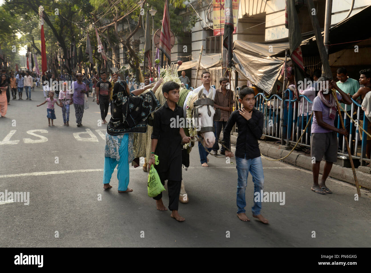 Kolkata, India. Xix Sep, 2018. Indiano musulmano sciita donne toccare un simbolico cavallo sacro per buona fortuna durante una processione precedendo di Muharram. Indiano musulmano sciita prendere parte in una processione durante i dieci giorni di lutto periodo fino a Ashura, commemora la morte dell imam Hussein che fu ucciso dagli eserciti del rivale Yazid vicino Karbal in 680annuncio. Credito: Saikat Paolo/Pacific Press/Alamy Live News Foto Stock