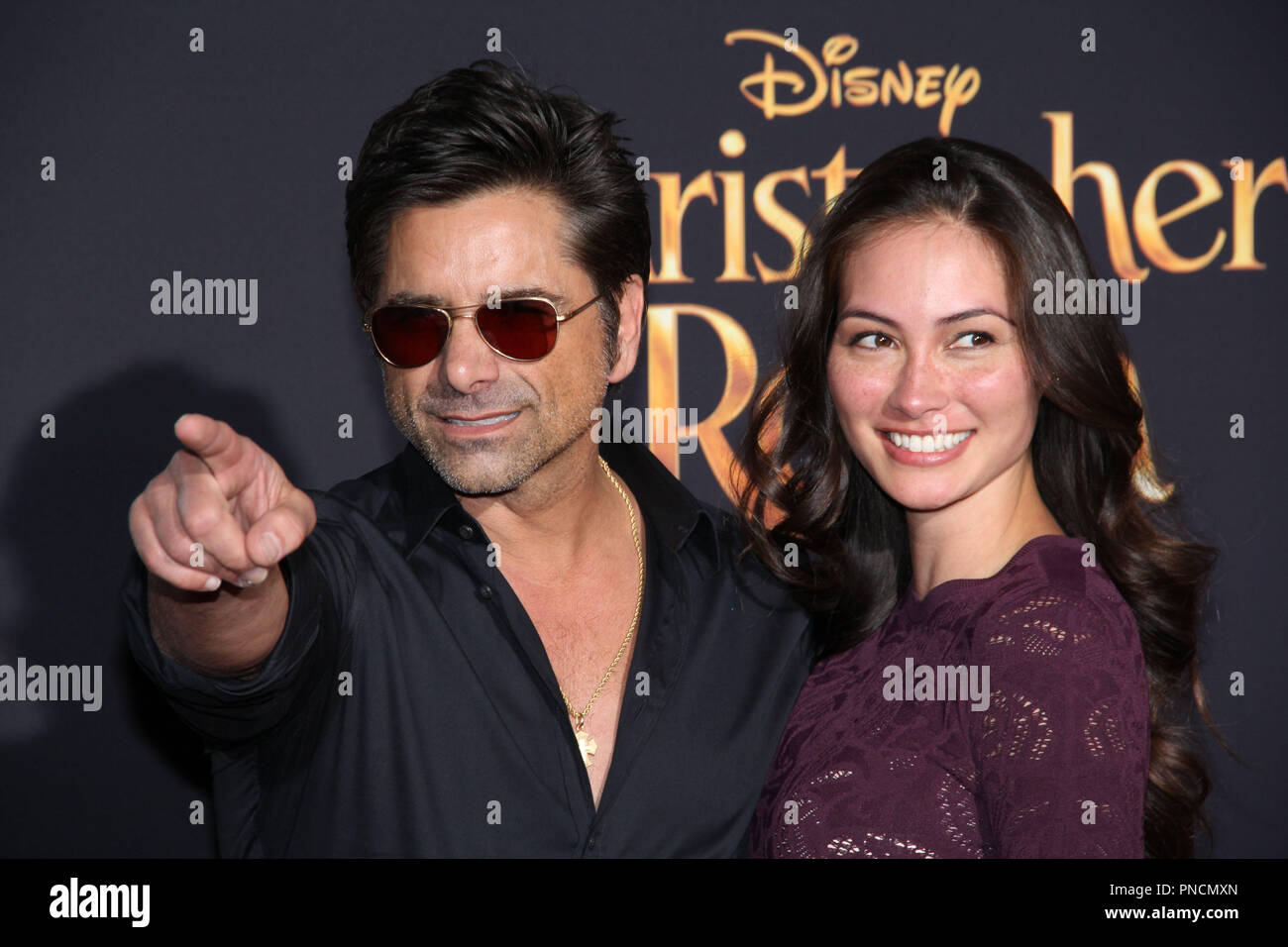 John Stamos e Caitlin McHugh presso il Disney's Premiere mondiale di "Christopher Robin'. Tenuto presso il Walt Disney Studios teatro principale di Burbank, CA, 30 luglio 2018. Foto: Richard Chavez / PictureLux Foto Stock