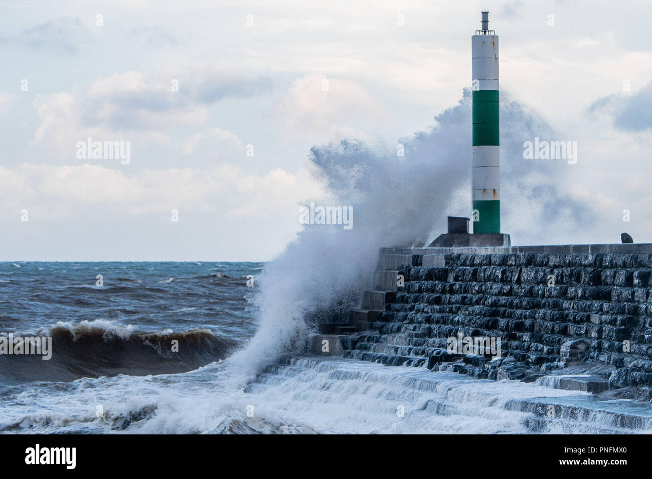 Aberystwyth Wales UK, venerdì 21 settembre 2018 UK Meteo: alla prima luce e con l'alta marea, il gale force venti di tempesta Bronagh, il secondo denominato storm del Regno Unito inverno , porta onde che si schiantano contro il porto faro in Aberystwyth Wales Foto © Keith Morris / Alamy Live News Foto Stock