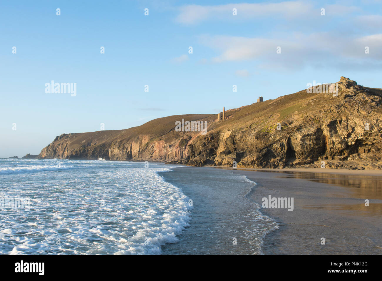 La spiaggia e le scogliere a cappella Porth, cercando fino a Wheal Coates miniera di stagno, camino e motore di casa sulla scogliera, Cornwall, Regno Unito. Settembre, Foto Stock