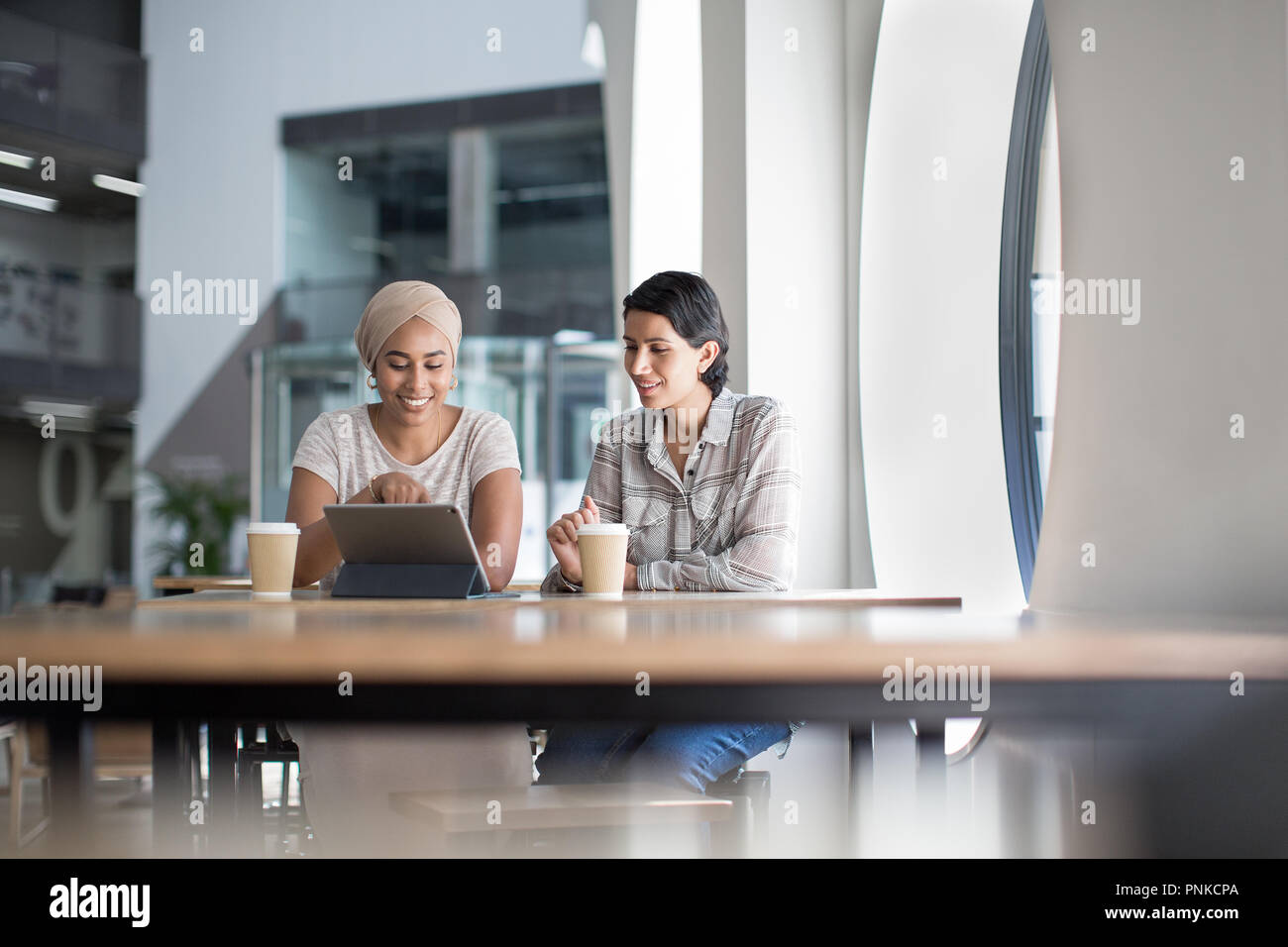 Imprenditrici musulmano avente una riunione in un ufficio Foto Stock