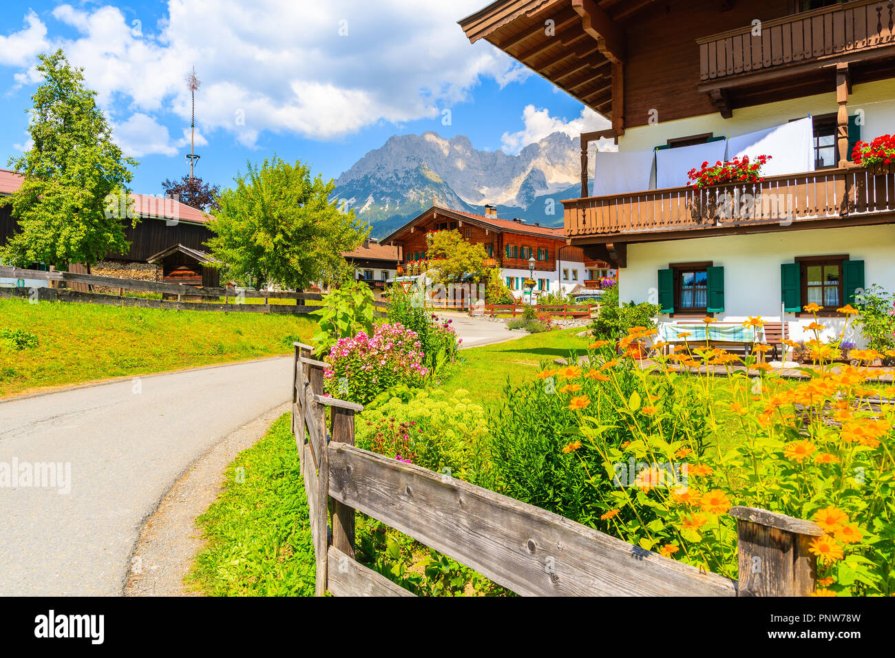 Strada a Going am Wilden Kaiser villaggio sulla soleggiata giornata estiva e splendide case tradizionali decorato con fiori, Tirolo, Austria Foto Stock