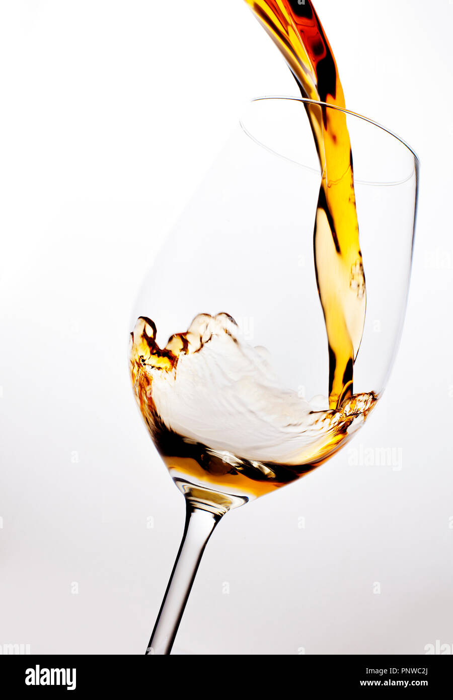 Versando il vino in un bicchiere da vino, isolato su sfondo bianco Foto Stock