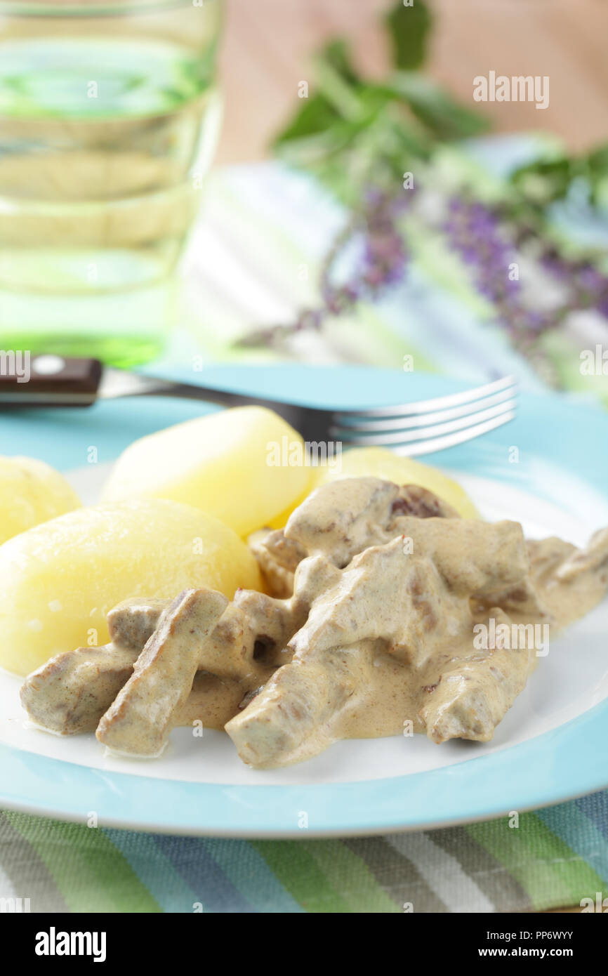 Carni bovine Stroganoff con patate bollite sulla piastra closeup Foto Stock