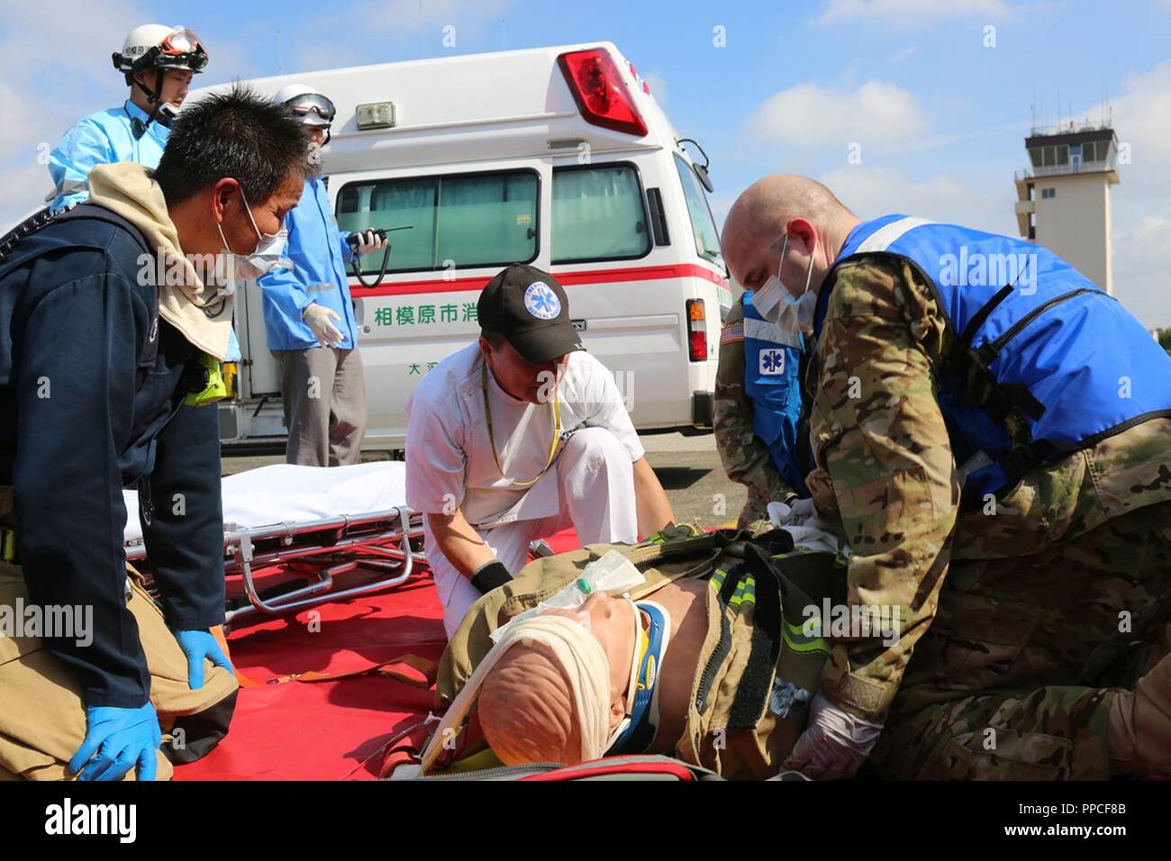 Primi responder da Camp Zama e Sagamihara città collaborano per curare feriti 21 agosto al Camp Zama Airfield durante la U.S. Army Garrison Giappone annuali di pieno esercizio della scala. Foto Stock