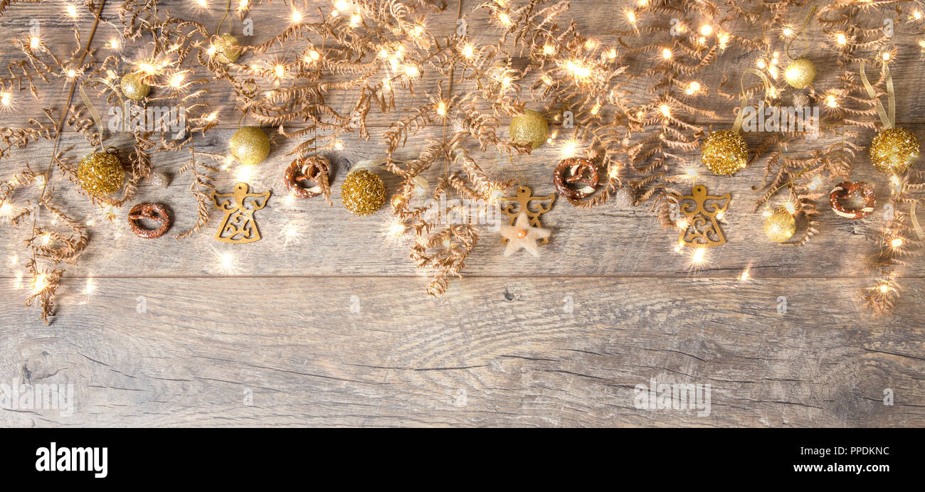 Golden decorazioni di Natale su sfondo lucido con copia spazio per il testo. Sfondo di Natale o il biglietto di auguri. Messa a fuoco selettiva. Foto Stock