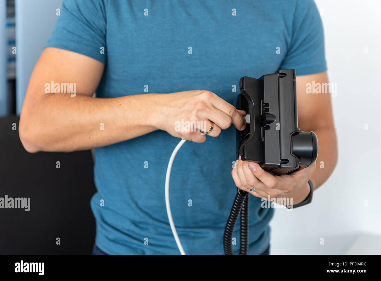 Telefonia VoIP, supporto tecnico, servizi. Specialista collega il telefono alla rete Foto Stock