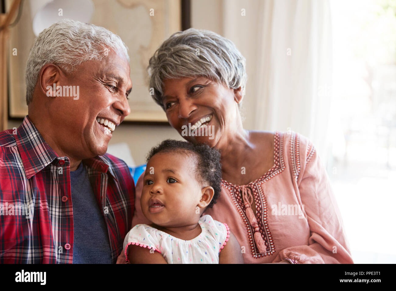 Nonni seduto sul divano con il bambino nipote a casa Foto Stock