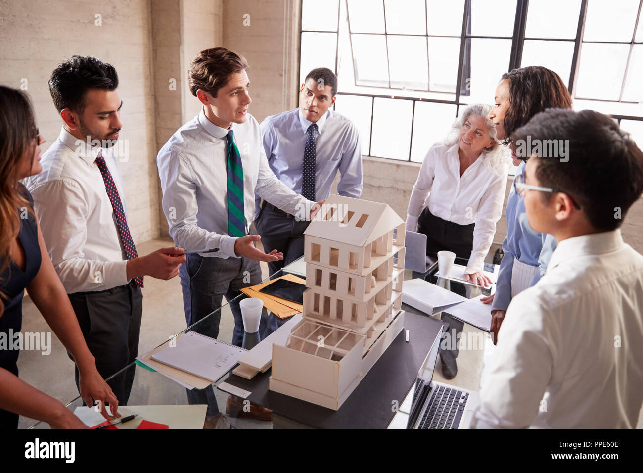 Architetto presentando un modello di progettazione ai colleghi di lavoro Foto Stock