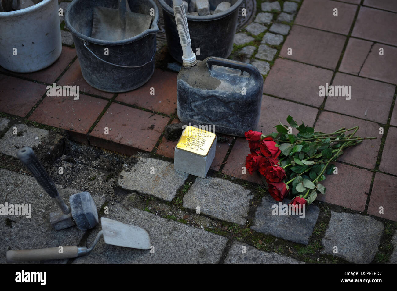 L'artista Gunter Demnig stabilisce un Stolperstein su giardini privati in Entenbachstrasse 45 per Viktoria Klimm, che era stato deportato dai nazisti ad Auschwitz nel luglio 1937. Lei è stato un testimone di Geova e fu perseguitato e ucciso per la sua fede. Foto Stock