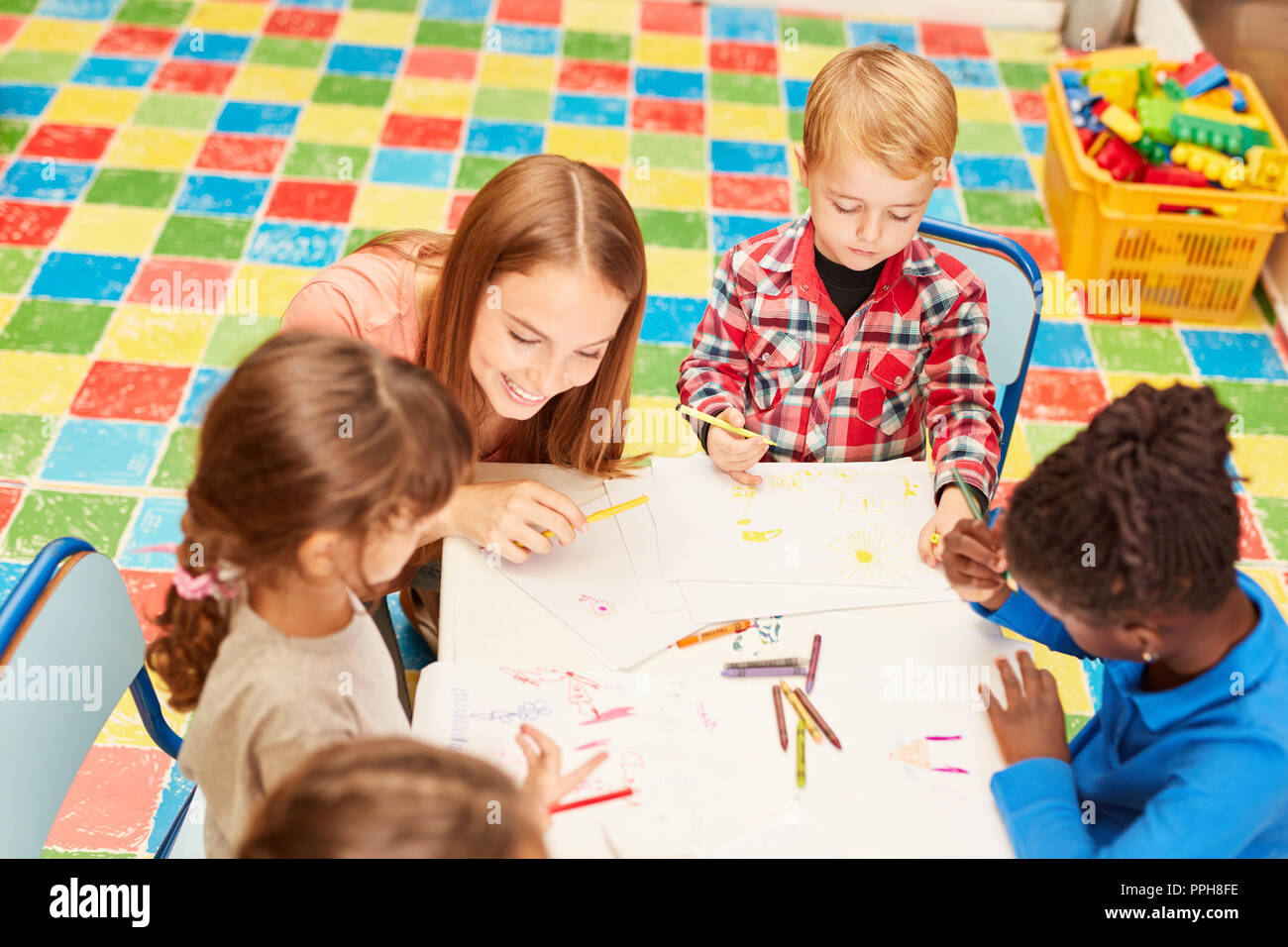 Insegnanti e bambini insieme nel disegno creativo classe in asilo nido o alla scuola materna Foto Stock