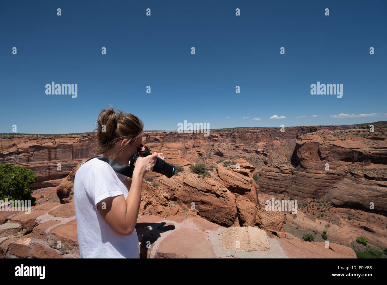 Donna femmina fotografo prende le foto con una fotocamera reflex digitale del Canyon De Chelly National Monument in Arizona Quattro Angoli area Foto Stock