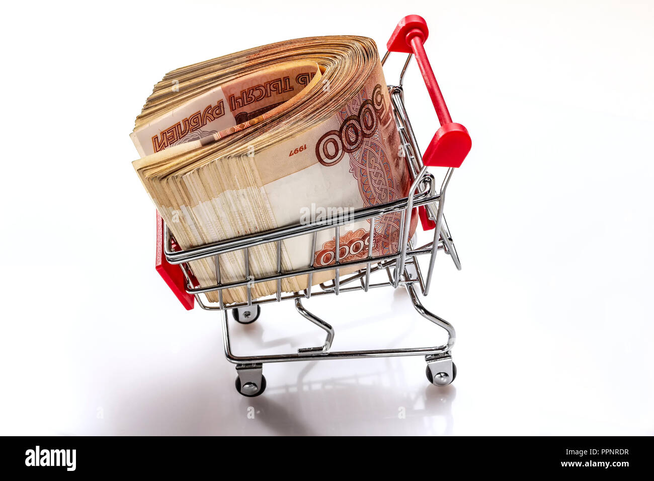 Carrello con il denaro. Un pacco di banconote russo 5000 rubli. Il denaro è nel carrello per supermercati. Finanziamento creativi. Servizio bancario. In isolamento. Foto Stock