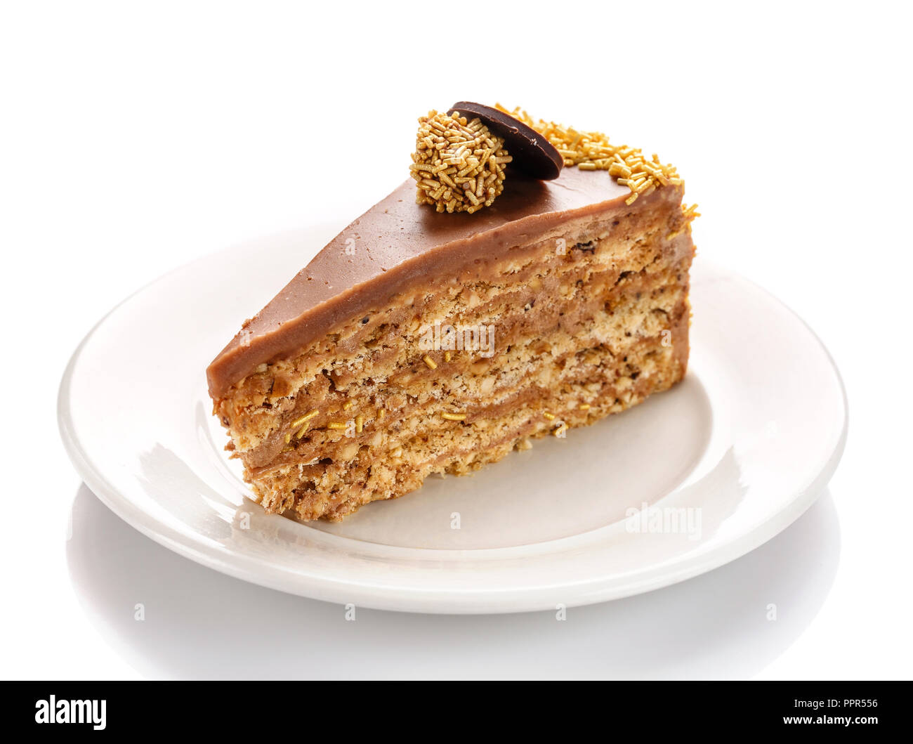 Un pezzo di torta al caramello, isolata su uno sfondo bianco. Torta con dado pralina. Foto Stock