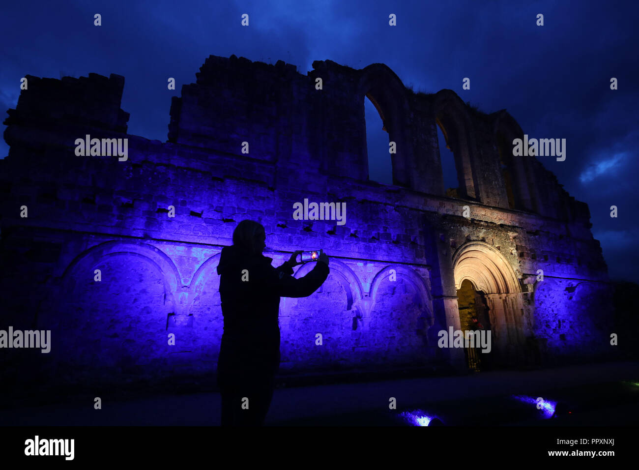 Rievaulx Abbey inondate di luce colorata in anticipo di Rievaulx illuminante, a tre notte luce e suono installazione presso l abbazia del XI secolo rovine nel North Yorkshire. Foto Stock