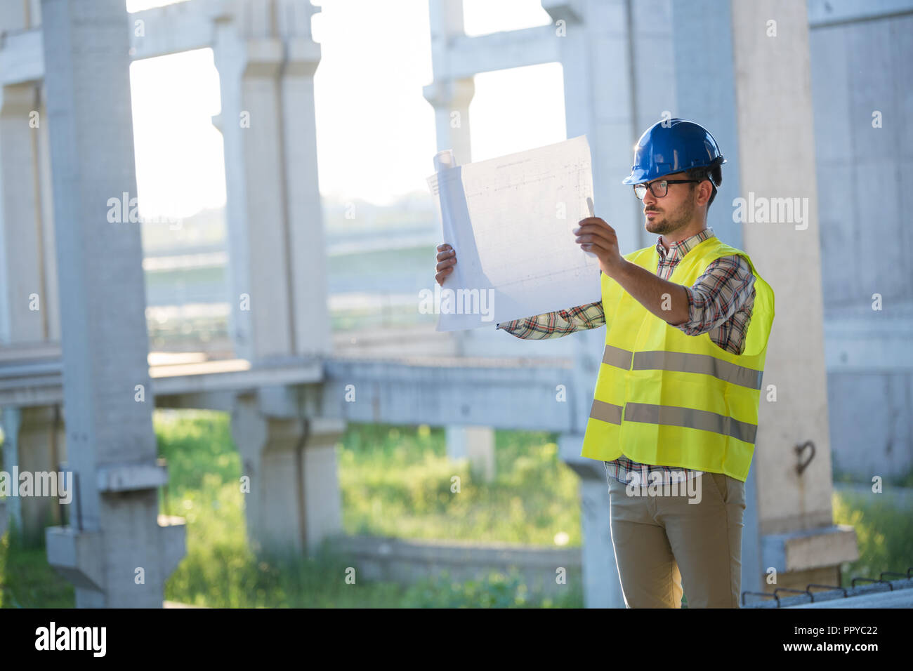 Immagine del sito in costruzione ingegnere guardando al plan Foto Stock