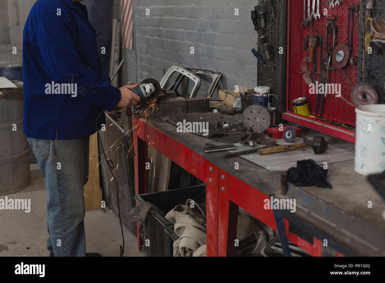 Maschio di macinazione meccanica macchina in garage Foto Stock