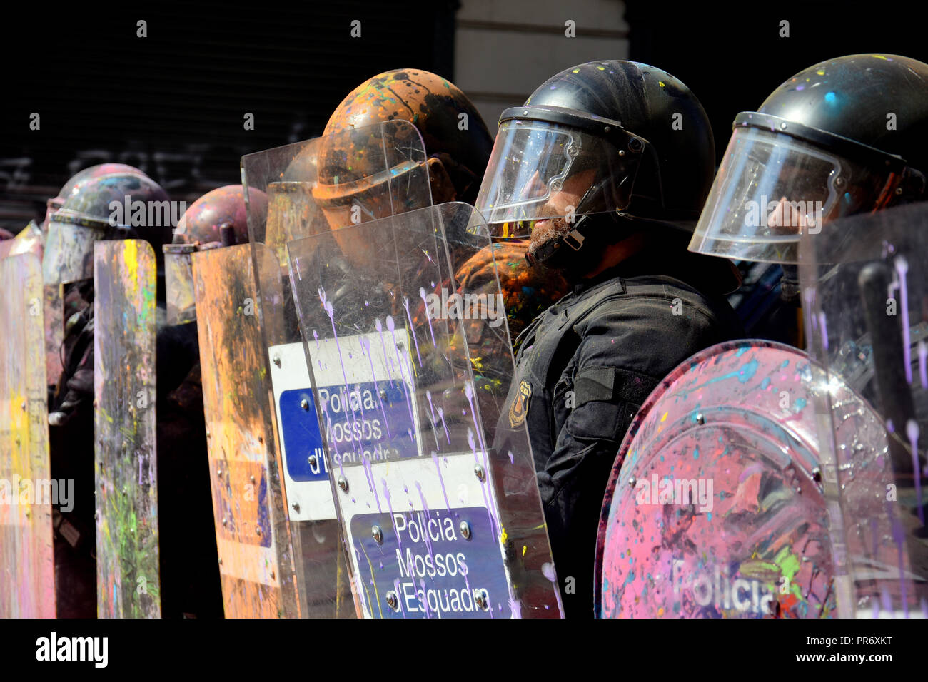 Il catalano poliziotti hanno visto con la vernice e polvere colorata in guardia durante la protesta. Scontri tra pro-indipendenza manifestanti e catalano polizia durante la protesta di JUSAPOL Sindacato di polizia che è stato a Barcellona che manifestavano per la parità salariale e omaggio alla polizia nazionale che ha impedito il referendum del 1 ottobre. Foto Stock