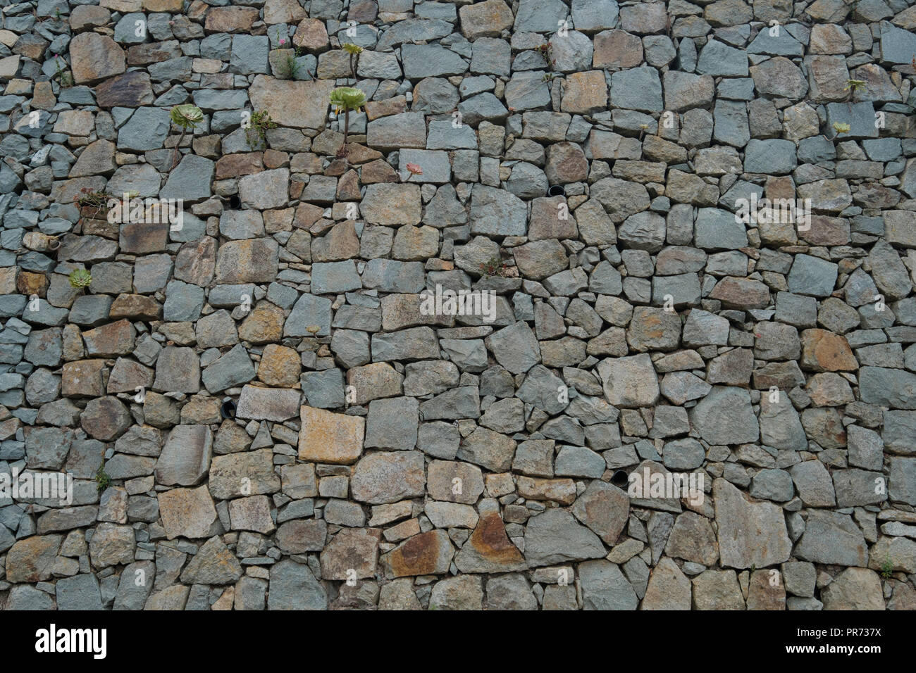 Muro di pietra naturale sfondo. La texture di un muro di pietra - Foto Stock